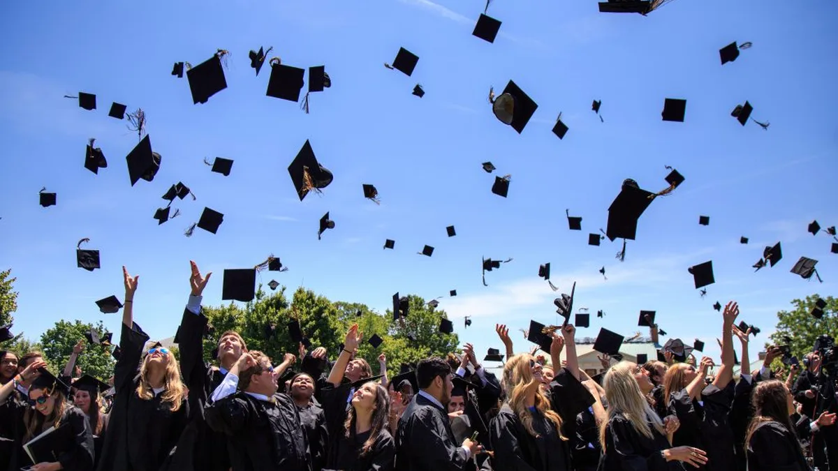 Graduates throwing caps in the air at a university convocation