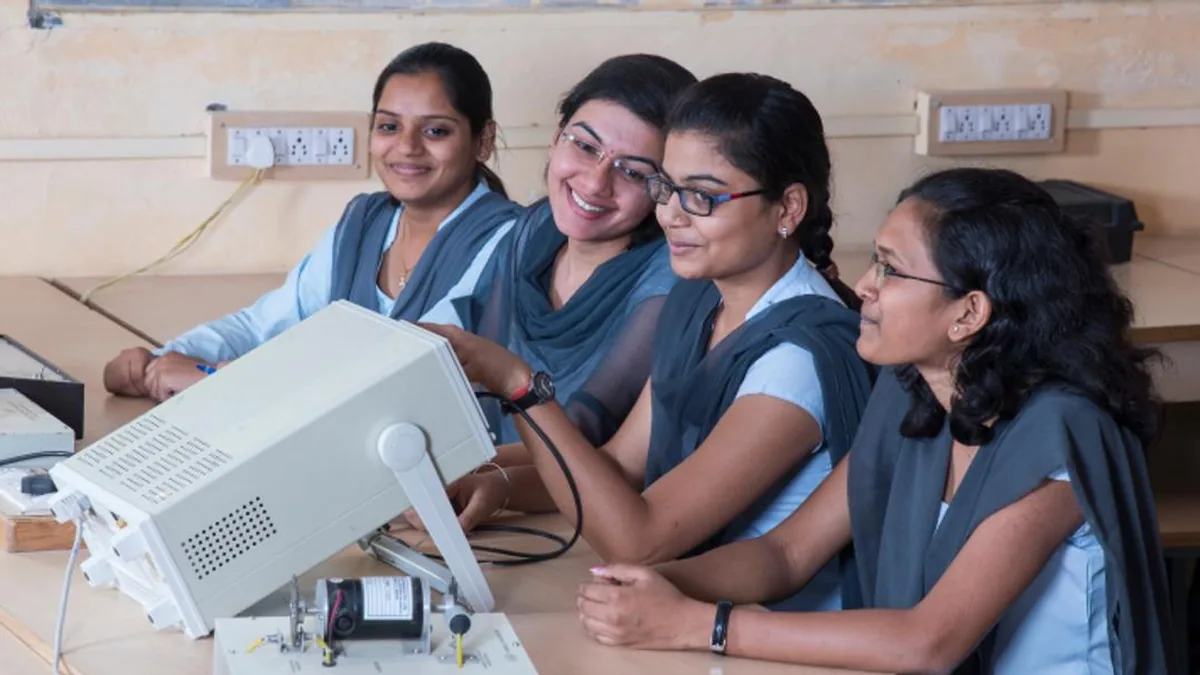 Four women engineering students working with lab equipment in an Indian college laboratory