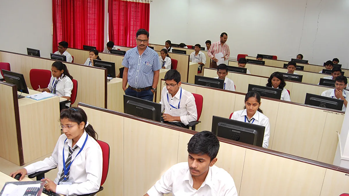 Students taking a computer-based examination in a college exam hall in India