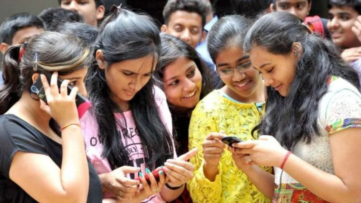 Indian college students checking their semester results on mobile phones