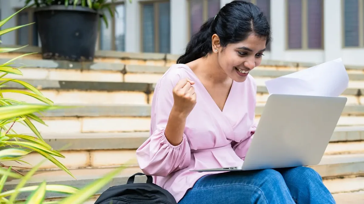A candidate checking a bank exam result on a laptop screen