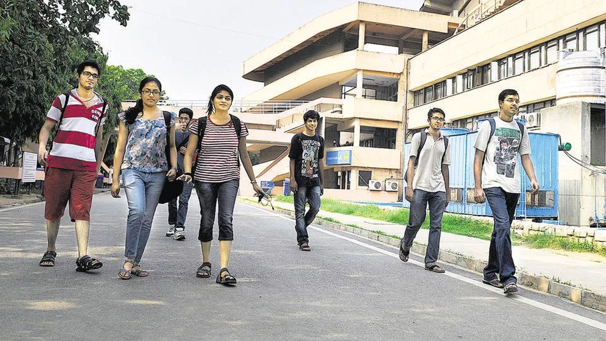 IIT students walking on a campus road in front of a university building