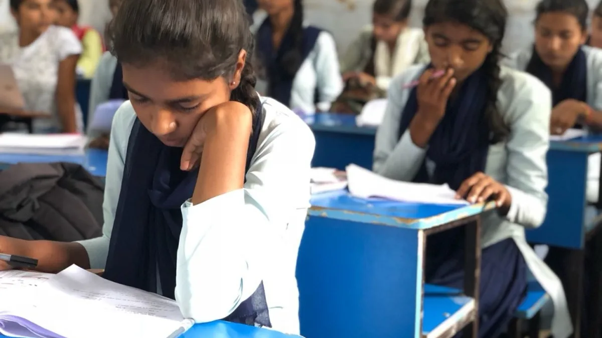 Indian girl students writing their examination in a classroom