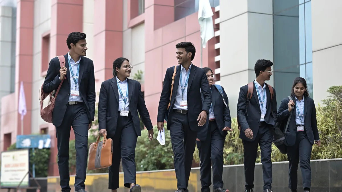 MBA students walking on a college campus in India after results