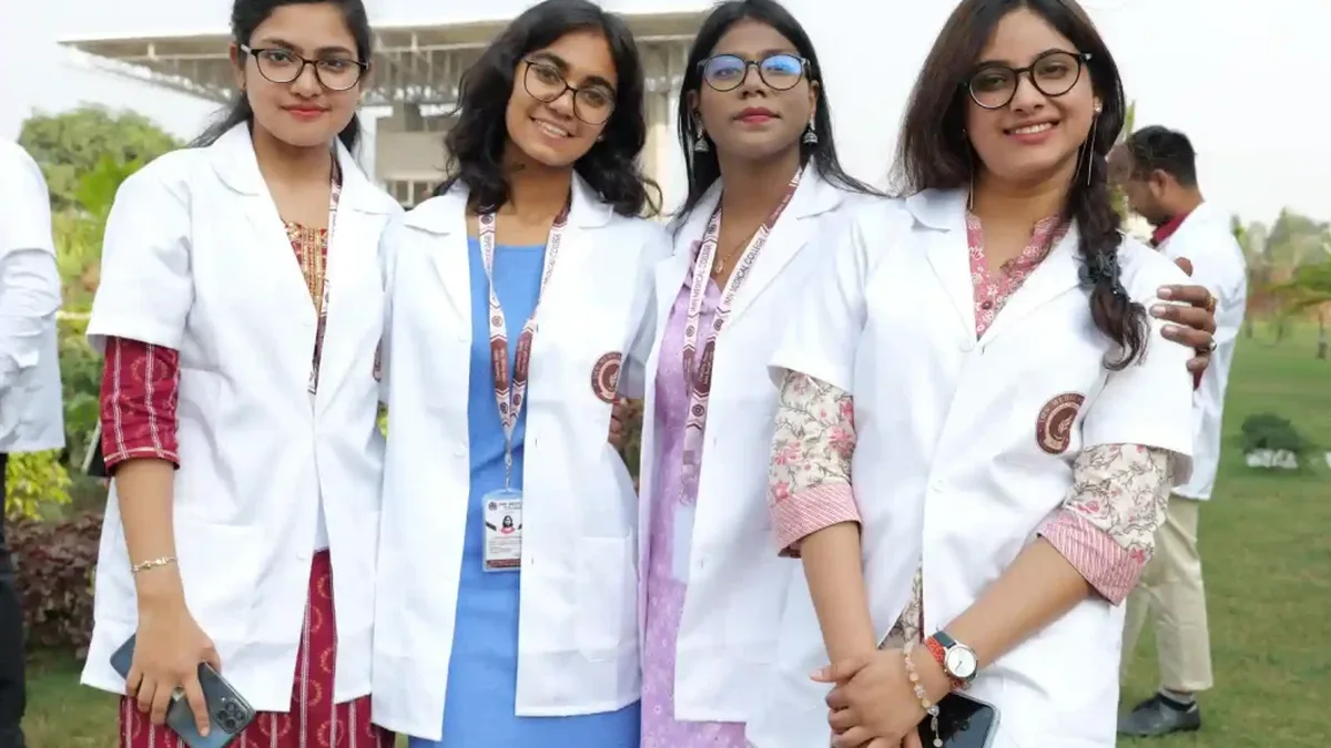 Medical students in white coats on a college campus in India