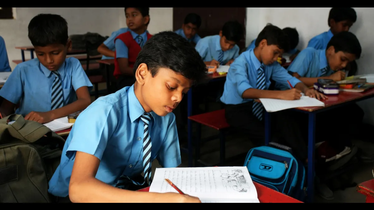 Indian school students in uniform writing in a classroom