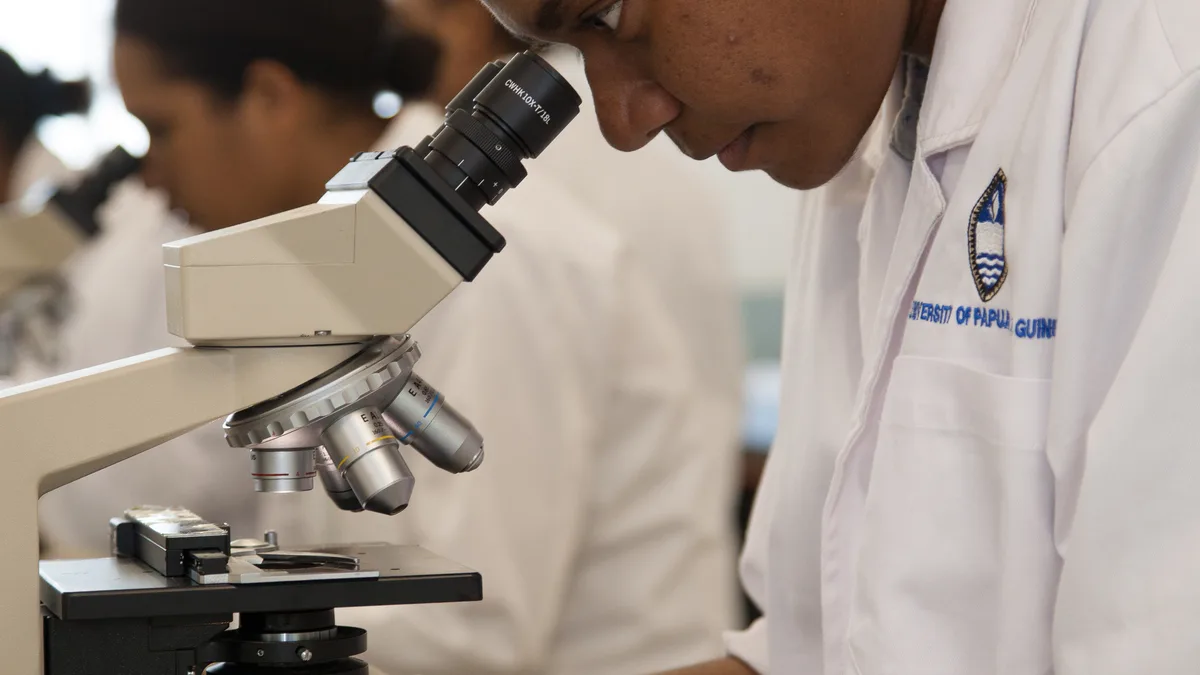 Medical students in white coats at a hospital during postgraduate admission season