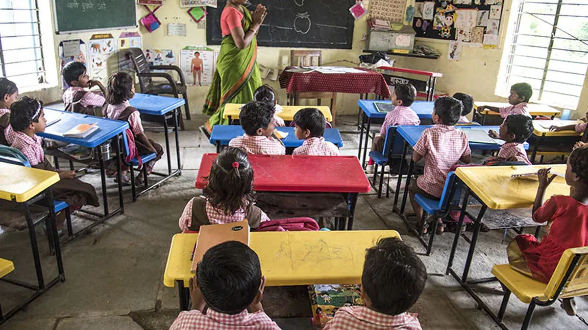 A teacher taking class with primary school students in an Indian classroom