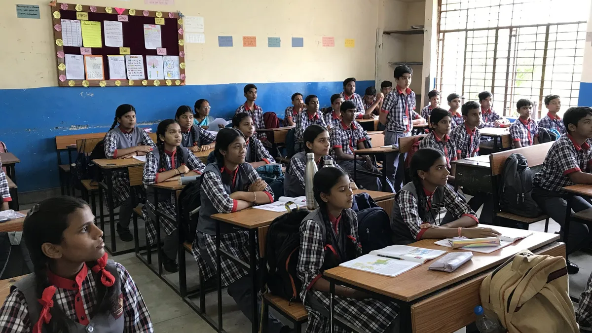 Indian school students attending classes in a government school classroom