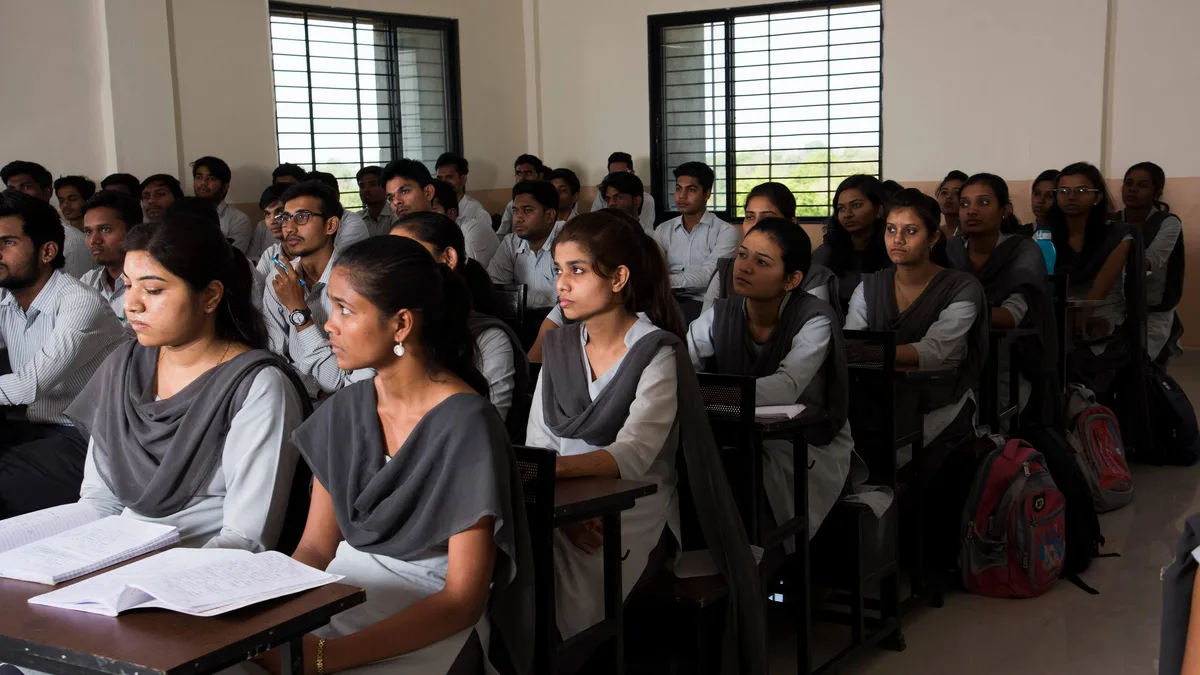 Indian college students attending a lecture in a classroom