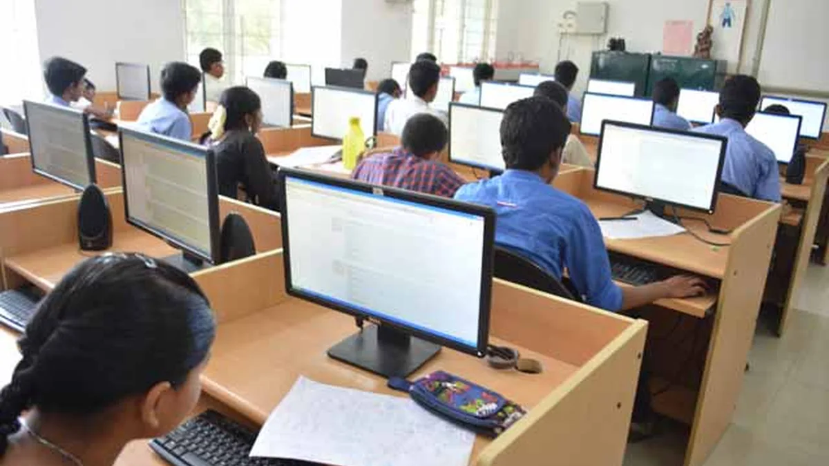 Students taking a computer-based test at an exam centre in India