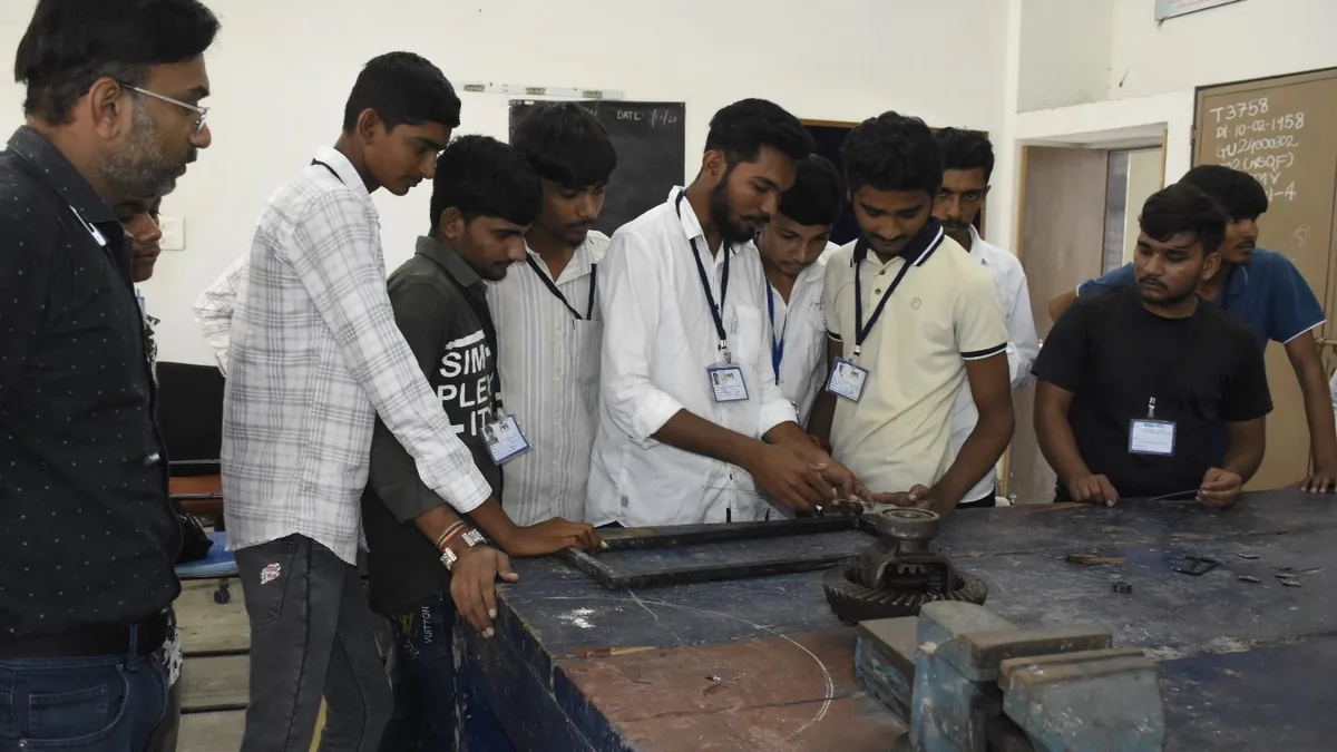 ITI students gathered around a workbench in a practical training workshop in India