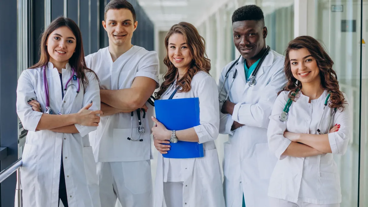 Young doctors in white coats standing together in a hospital corridor in India
