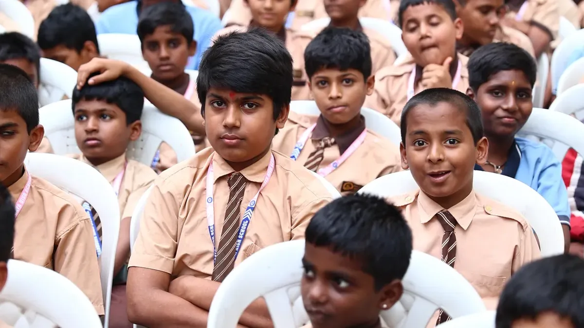 School students in uniform seated at a school assembly in India