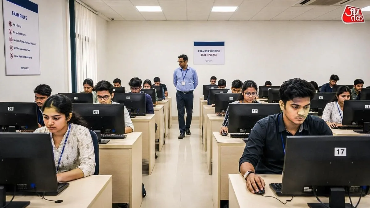 Students taking a computer-based entrance exam in an exam hall in India